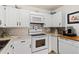 Bright white kitchen with ample cabinetry, built-in microwave, and modern appliances at 750 S Clinton St # 12D, Denver, CO 80247