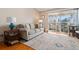 Cozy living room with hardwood floors, neutral decor, and access to a private balcony at 750 S Clinton St # 12D, Denver, CO 80247