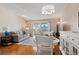 Bright living room features hardwood floors, a dining area, and access to a patio at 750 S Clinton St # 12D, Denver, CO 80247