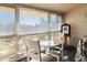 Bright sunroom with large windows, table and chairs, offering a view of the outdoors at 750 S Clinton St # 12D, Denver, CO 80247