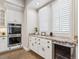 Well-equipped kitchen featuring double ovens, granite countertops, and ample cabinetry at 3575 E Cedar Ave, Denver, CO 80209