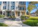 Modern townhome with blue door and landscaping at 888 S Valentia St # 104, Denver, CO 80247