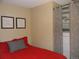 Bedroom with red bedding, built-in closet and storage at 1020 15Th St # 26I, Denver, CO 80202