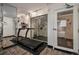 Treadmill in fitness center with mirrored wall and access door at 1020 15Th St # 26I, Denver, CO 80202