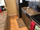 Compact kitchen with stainless steel appliances, marble countertops, and tiled floor at 1020 15Th St # 26I, Denver, CO 80202