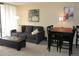 Living room with a comfortable couch, dining table, and large window at 1020 15Th St # 26I, Denver, CO 80202