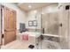 Bathroom features a large shower, soaking tub and neutral tile at 7818 Vallagio Ln, Englewood, CO 80112