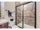 Bathroom with shower, toilet and wood cabinets at 7818 Vallagio Ln, Englewood, CO 80112