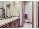 Bathroom with a sink, vanity, and wood cabinets at 7818 Vallagio Ln, Englewood, CO 80112