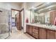 Spa-like bathroom with double vanity and large shower at 7818 Vallagio Ln, Englewood, CO 80112