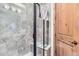 Bathroom with shower stall, tiled walls, and built-in bench at 7818 Vallagio Ln, Englewood, CO 80112