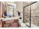 Bathroom with shower, toilet, sink vanity, and wood cabinets at 7818 Vallagio Ln, Englewood, CO 80112