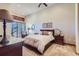 Comfortable bedroom with plush carpet and wood furniture at 7818 Vallagio Ln, Englewood, CO 80112