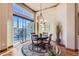 Charming dining room with hardwood floors, a round table and large windows at 7818 Vallagio Ln, Englewood, CO 80112