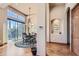 Bright dining room with hardwood floors, a round table, and access to a deck at 7818 Vallagio Ln, Englewood, CO 80112