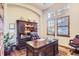 Elegant home office with built-in cabinetry and hardwood floors at 7818 Vallagio Ln, Englewood, CO 80112