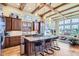 Spacious kitchen with granite island, dark wood cabinets and stainless steel appliances at 7818 Vallagio Ln, Englewood, CO 80112
