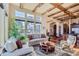 Sunlit living room with hardwood floors, exposed beams, and comfortable seating at 7818 Vallagio Ln, Englewood, CO 80112