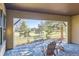 Covered patio with seating and a view of the golf course at 7818 Vallagio Ln, Englewood, CO 80112