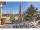 Patio with table, chairs, umbrella, and golf course view at 7818 Vallagio Ln, Englewood, CO 80112