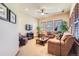 Spacious sitting room with leather sofas, a coffee table, and large windows at 7818 Vallagio Ln, Englewood, CO 80112