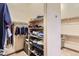 Large walk-in closet with shelving and hanging space at 7818 Vallagio Ln, Englewood, CO 80112