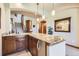 Wet bar with granite countertop and wood cabinets at 7818 Vallagio Ln, Englewood, CO 80112