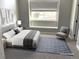 Virtually staged bedroom with a queen bed and sitting chair at 4760 S Wadsworth Blvd # 205, Littleton, CO 80123