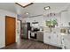 White kitchen with stainless steel appliances and breakfast bar at 295 E Amherst Ave, Englewood, CO 80113