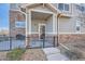 Townhome's front entrance with a covered porch and small patio at 1781 S Buchanan Cir, Aurora, CO 80018