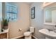 Clean powder room with pedestal sink, toilet, and decorative wall art at 1781 S Buchanan Cir, Aurora, CO 80018