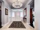 Elegant entryway with chandelier, ornate rug, and view to kitchen at 4101 E 17Th Avenue Pkwy, Denver, CO 80220