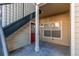 Private entrance with stairs and red door at 5800 Tower Rd # 503, Denver, CO 80249