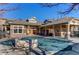 Community pool and patio area with covered seating at 5800 Tower Rd # 503, Denver, CO 80249