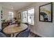 Bright dining area with wooden table and four chairs, overlooking backyard at 12986 E 103Rd Ave, Commerce City, CO 80022