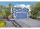 Two-story home with a blue exterior and stone accents at 5109 S Malta Way, Centennial, CO 80015