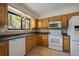 Kitchen features wood cabinets, tiled floors, and a window overlooking trees at 720 Arapahoe Dr, Monument, CO 80132