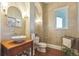 Stylish powder room with a vessel sink and hardwood floors at 3594 Palmer Ridge Dr, Parker, CO 80134