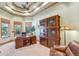 Functional home office with built-in shelving and large windows at 3594 Palmer Ridge Dr, Parker, CO 80134