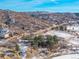 Aerial view showing the property's location near a road and hills at 567 Lake Gulch Rd, Castle Rock, CO 80104