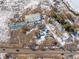 Aerial image showing a house, workshop, and outbuildings on the property at 567 Lake Gulch Rd, Castle Rock, CO 80104