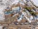 Aerial view of property with various buildings and vehicles in snowy landscape at 567 Lake Gulch Rd, Castle Rock, CO 80104