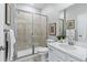 Clean bathroom with a shower/tub combo, white vanity and neutral tile at 4194 Ridgewalk Pt, Castle Rock, CO 80108