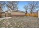 Large backyard with detached garage and fire pit at 7251 Raritan St, Denver, CO 80221