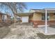 Covered carport with attached garage and brick exterior at 7251 Raritan St, Denver, CO 80221