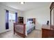 Charming bedroom with wood bed frame and window at 3211 Westbrook Ln, Highlands Ranch, CO 80129