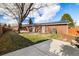 Brick home with large backyard, patio, and solar panels at 10698 W 26Th Ave, Lakewood, CO 80215