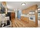 Bright kitchen with wood cabinets, stainless steel appliances, and hardwood floors at 10698 W 26Th Ave, Lakewood, CO 80215