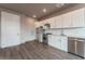 Modern kitchen with white cabinets and stainless steel appliances at 12983 W Ida Ave # 111, Littleton, CO 80127