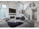 Modern living room with a fireplace, staircase, and ample natural light at 6183 Stable View St, Castle Pines, CO 80108